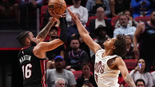 Dec 8, 2023; Miami, Florida, USA; Miami Heat forward Caleb Martin (16) shoots over Cleveland Cavaliers guard Craig Porter (9) during the second half at Kaseya Center.